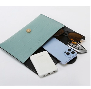 Mint green croc-embossed clutch bag storage capacity with phone and accessories