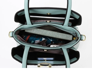 Macro view showing triple interior compartments of mint green faux leather tote bag
