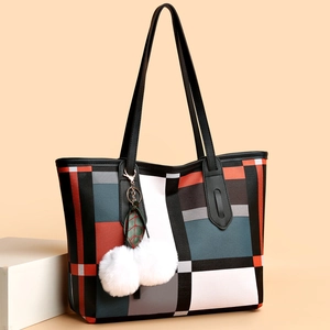 Large geometric pattern tote bag with plush pompom charm and thin black shoulder straps
