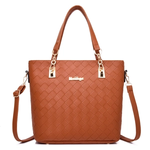 Brown woven leather tote bag with top handles and adjustable shoulder strap