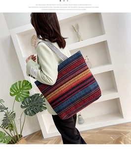 Ethnic style woven canvas tote bag with geometric diamond patterns and striped shoulder strap