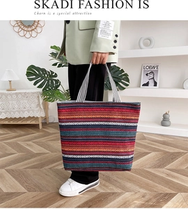 Detail of colorful geometric striped woven canvas tote bag with striped handles
