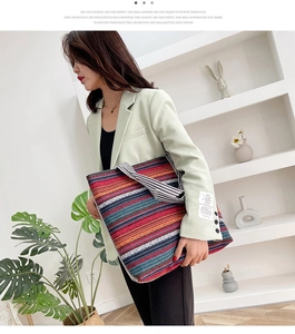Detailed close-up of a large ethnic style woven tote bag with colorful striped patterns