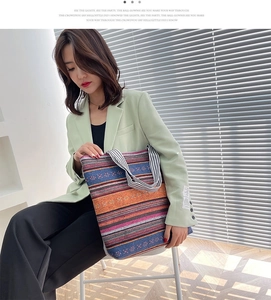 Detail of ethnic canvas tote bag with colorful stripes and geometric embroidery