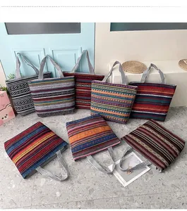 Detailed overhead view of multiple bohemian canvas tote bags with ethnic geometric patterns
