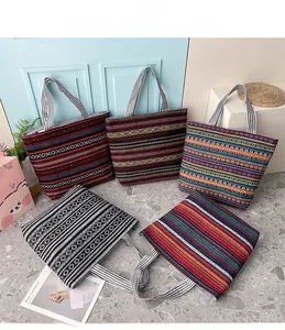 Ethnic canvas tote bags with colorful geometric patterns and striped shoulder straps