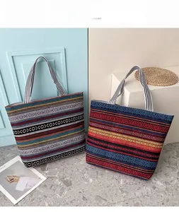 Detail view of two Bohemian canvas tote bags with colorful ethnic patterns and sturdy handles