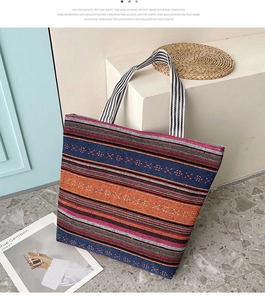 Detail of colorful striped woven tote bag with ethnic pattern and durable ribbon handles