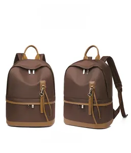 Front and 45-degree angle view of a brown water-resistant nylon backpack with tassel zippers
