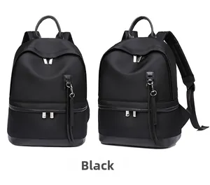Close-up of black waterproof nylon backpack with silver zippers and long leather pullers
