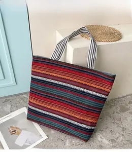 Detailed view of bohemian striped canvas tote bag with woven colorful ethnic patterns