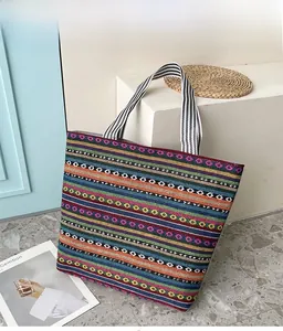 Detailed close-up of a large ethnic tote bag with colorful horizontal woven stripes