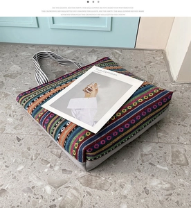Detailed close-up of bohemian woven canvas tote bag with colorful ethnic stripe patterns