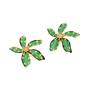 Detail of green floral earrings with yellow polka dots and golden flower center