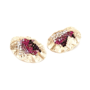 Detail of gold irregular wavy earrings with multi-color gradient rhinestone inlay
