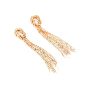Macro shot of gold knotted tassel earrings with fine snake chain strands on white background