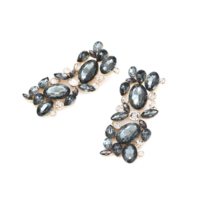 Macro shot of vintage gold floral earrings with grey and clear crystal embellishments