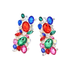 Close-up of vintage gold earrings with colorful rhinestones in geometric floral design