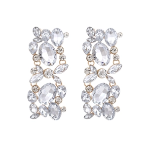 Macro view of gold vintage floral drop earrings with clear rhinestones and crystals