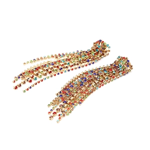 Detailed view of long tassel earrings with vibrant multi-colored crystal claw chains