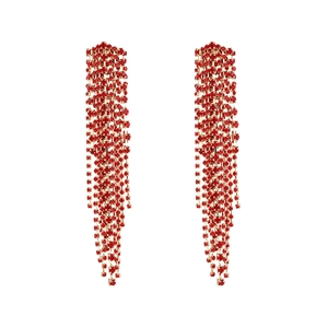 Detailed view of long gold tassel earrings with shimmering red rhinestones for parties