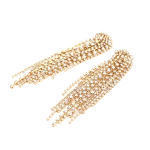 Detail of long gold tassel earrings with colorful rhinestones and sparkling metal chains