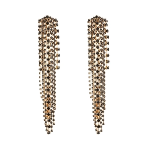 Detail of long fringe drop earrings featuring black rhinestones on gold-tone chains