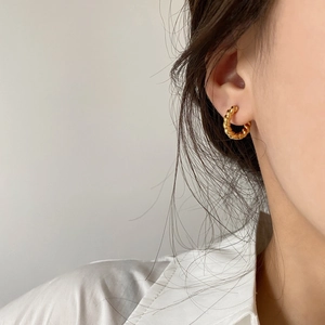 Minimalist twisted golden hoop earrings for women with elegant textured metal design