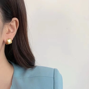 Elegant gold square minimalist earrings for women shown on a model side profile