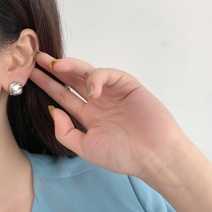 Minimalist square silver stud earrings for women featuring a polished mirror finish on ears