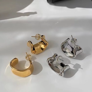 Irregular wavy C-shape wide metal earrings in polished gold and silver finishes