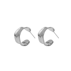 Detail view of silver S925 irregular C-shaped wide hoop earrings with wavy texture