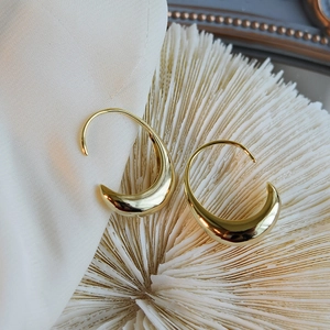 Minimalist 18K gold plated brass drop earrings with teardrop shape on white silk fabric