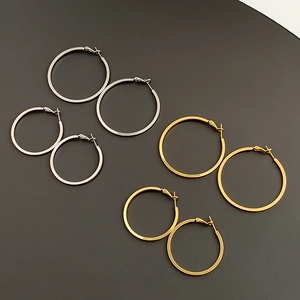 Macro view of gold and silver hoop earrings set in large and small sizes with polished finish