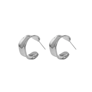Irregular C-shaped silver earrings with wavy twist design and polished metallic finish