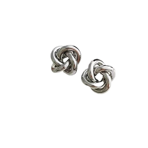 Polished silver geometric love knot stud earrings with a minimalist metallic finish