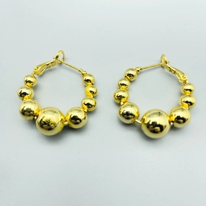 Exaggerated golden beaded hoop earrings with gradient metallic beads in geometric style