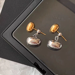 Elegant 18K gold and silver two-tone oval drop earrings on a premium black display box