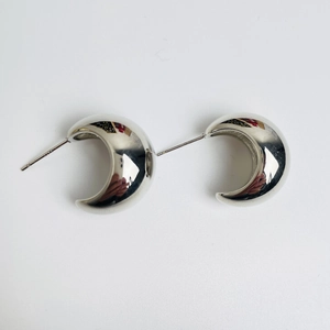 Polished silver C-shaped crescent stud earrings with a minimalist mirror finish