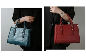 Close-up of crocodile pattern texture on red and teal blue tote bags with metal studs