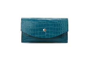 Detail of teal crocodile embossed faux leather wallet with gold snap button closure