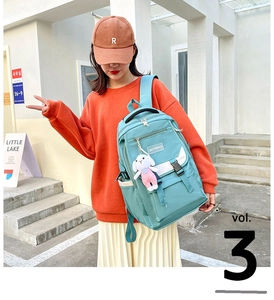 Detail of teal nylon backpack with cute bunny pendant and JIAYIBAG logo patch