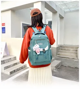Light green high-capacity school backpack with cute bunny pendant for students