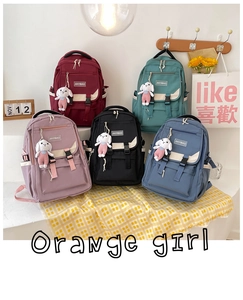 Detailed row of nylon school backpacks in five colors with cute bunny charms