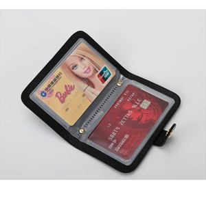 Detail view of black crocodile pattern card holder with transparent inner slots