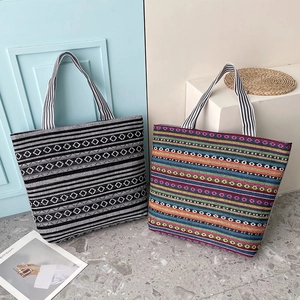 Ethnic style canvas tote bags with colorful geometric patterns and striped handles