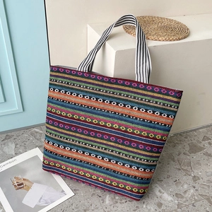 Ethnic bohemian canvas tote bag with multi-colored geometric stripes and woven handles