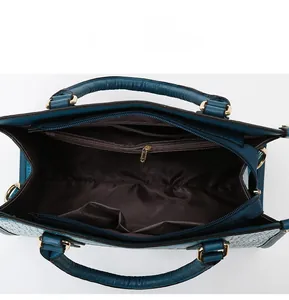 Internal layout of crocodile pattern handbag with multi-compartments and gold hardware