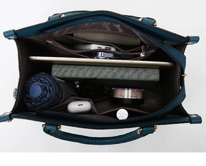 Top view of spacious interior of dark blue tote bag with compartments and personal items