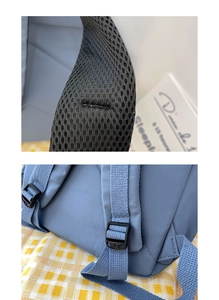 Detail of blue backpack padded shoulder straps with breathable mesh and plastic buckles